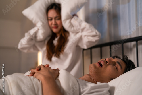 Photos Asian woman feel frustrated from husband snoring while sleep at night
