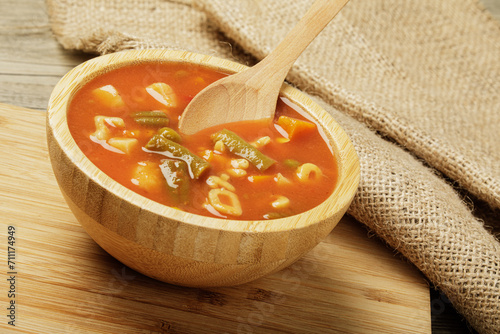 Delicious Canned Vegetable Soup on a wooden background photo