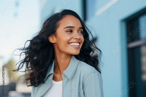 beautiful smiling young african american woman in casual clothes looking away