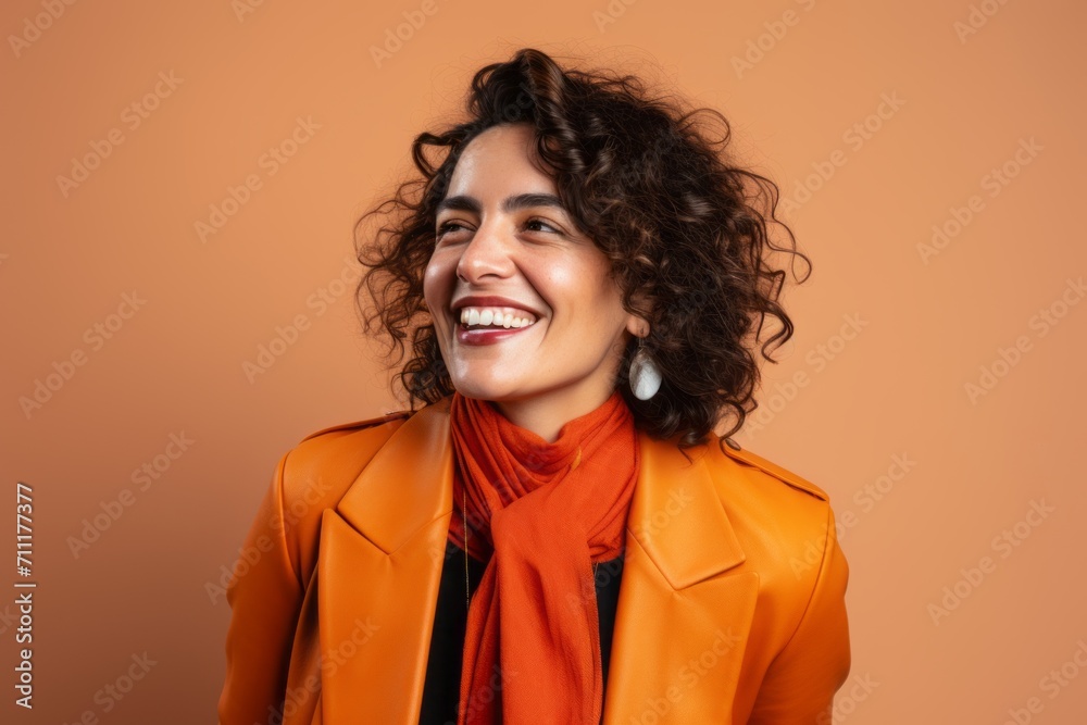 Portrait of a beautiful young woman with curly hair and orange coat Portrait of a beautiful young woman with curly hair and orange coat