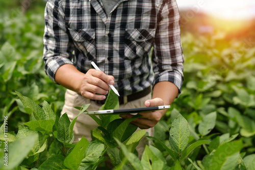 Hands of farmer, Agriculture technology farmer man using tablet Modern technology concept agriculture.