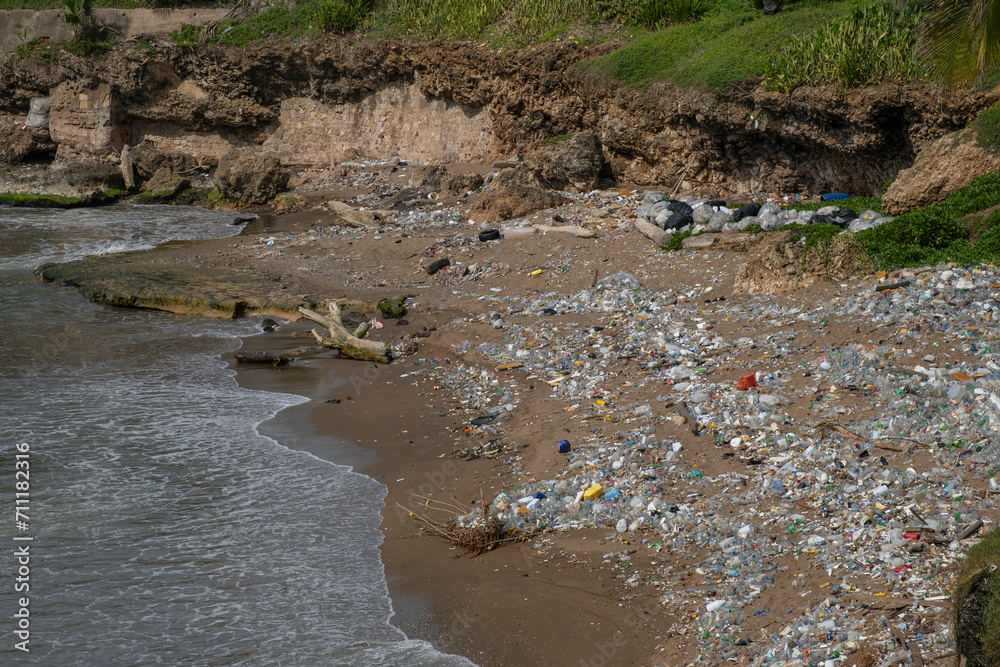 City public beach covered with washed off to the shore plastic trash. Environment issues, pollution, recycling concept. City public beach covered with washed off to the shore plastic trash. Environment issues, pollution, recycling concept.