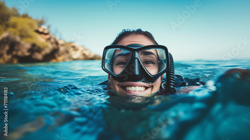 Close-up of a happy woman above the sea surface after diving
