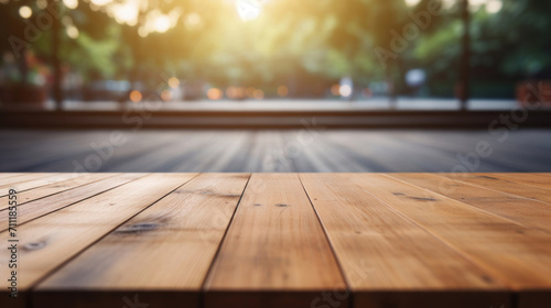 Warm sunlight bathes a smooth wooden table top with a softly blurred park scene in the background.