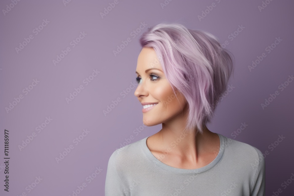 Portrait of a beautiful woman with pink hair on a purple background