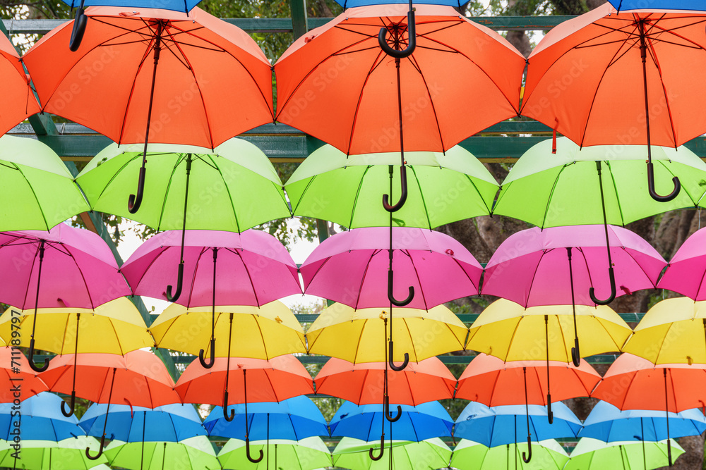 Obraz premium Bottom view of colorful canopy of umbrellas in a park