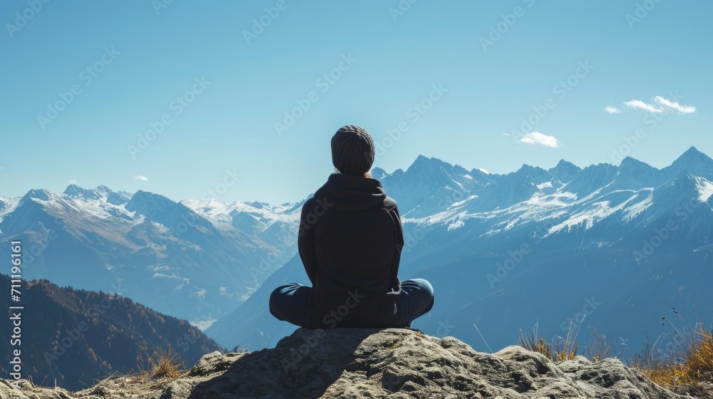 person sitting on a rock, observing a distant mountain range under a clear blue sky generative ai person sitting on a rock, observing a distant mountain range under a clear blue sky generative ai