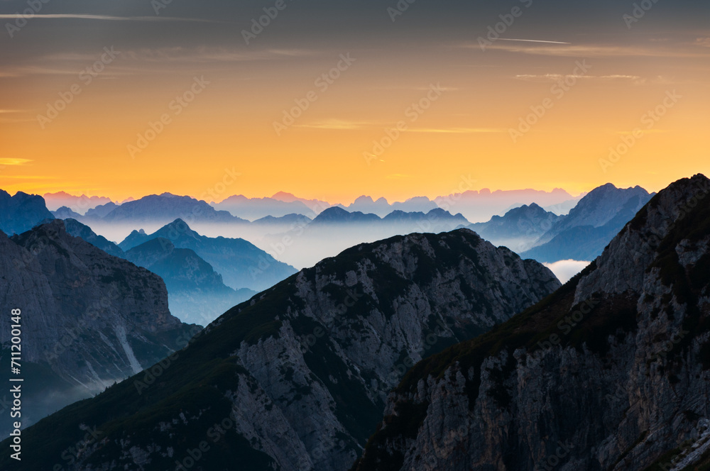 European Alps in Sunset Clouds Close UP Silhouette background - view from Mangart Saddle in Slovenia Europe