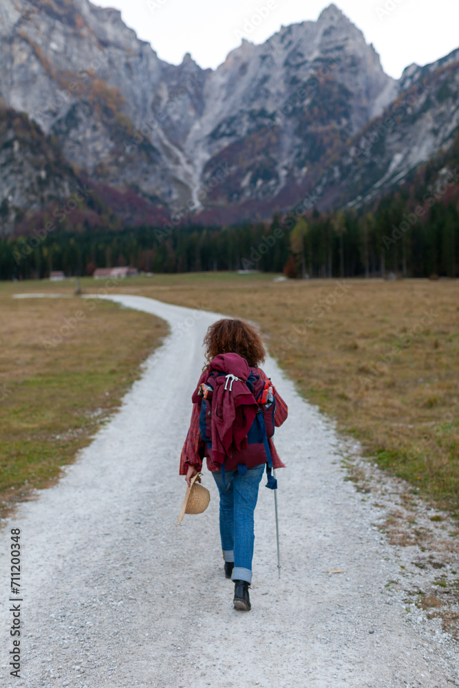 Adult Woman Hiker Enjoying a Tranquil Walk  on an Alpine Mountain Trail