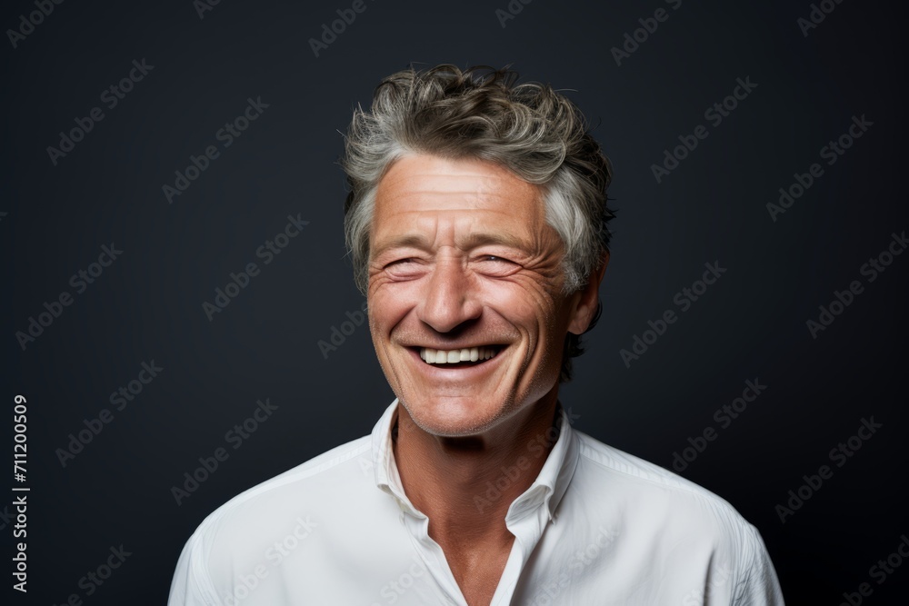Portrait of a happy mature man laughing. Isolated on black background. Portrait of a happy mature man laughing. Isolated on black background.
