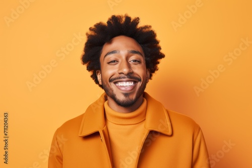 Cheerful african american man with afro hairstyle in yellow hoodie