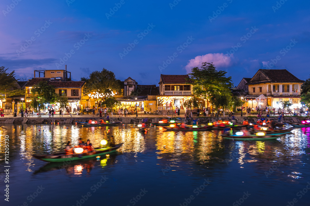 Scenery of Hoi An ancient town by Thu Bon River in Vietnam at night