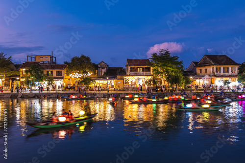 Scenery of Hoi An ancient town by Thu Bon River in Vietnam at night photo