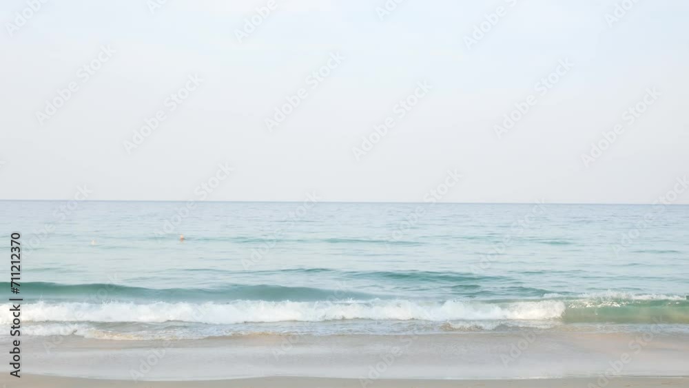 Summer sea in sunny day beautiful Tropical seashore scenic in phuket beach with wave crashing on sandy beach,wave hit the beach with white bubble, summer holiday vacation Summer sea in sunny day beautiful Tropical seashore scenic in phuket beach with wave crashing on sandy beach,wave hit the beach with white bubble, summer holiday vacation