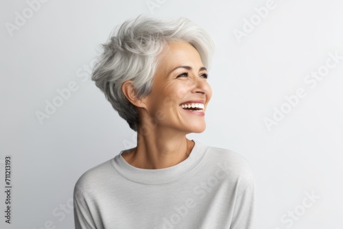 Portrait of happy senior woman with grey hair, isolated on white background