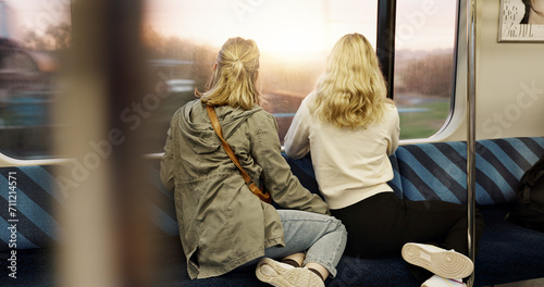 Women, back view and train window with travel, journey with commute or tourism, transportation and sightseeing. Friends are together, traveller and adventure with trip, public transport and metro photo