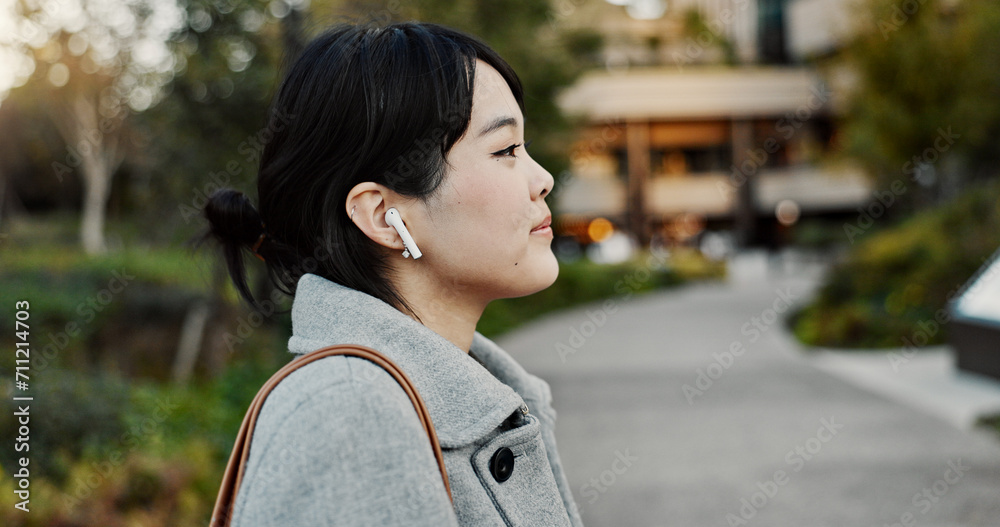 Japanese woman, earphones and walk in street with listening, music and streaming subscription in city. Business person, audio tech and sound for podcast, radio and travel on metro sidewalk in Tokyo Japanese woman, earphones and walk in street with listening, music and streaming subscription in city. Business person, audio tech and sound for podcast, radio and travel on metro sidewalk in Tokyo