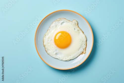 Delicious breakfast with fried egg on blue plate photo