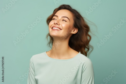 happy smiling young woman or teenage girl in casual clothes over blue background