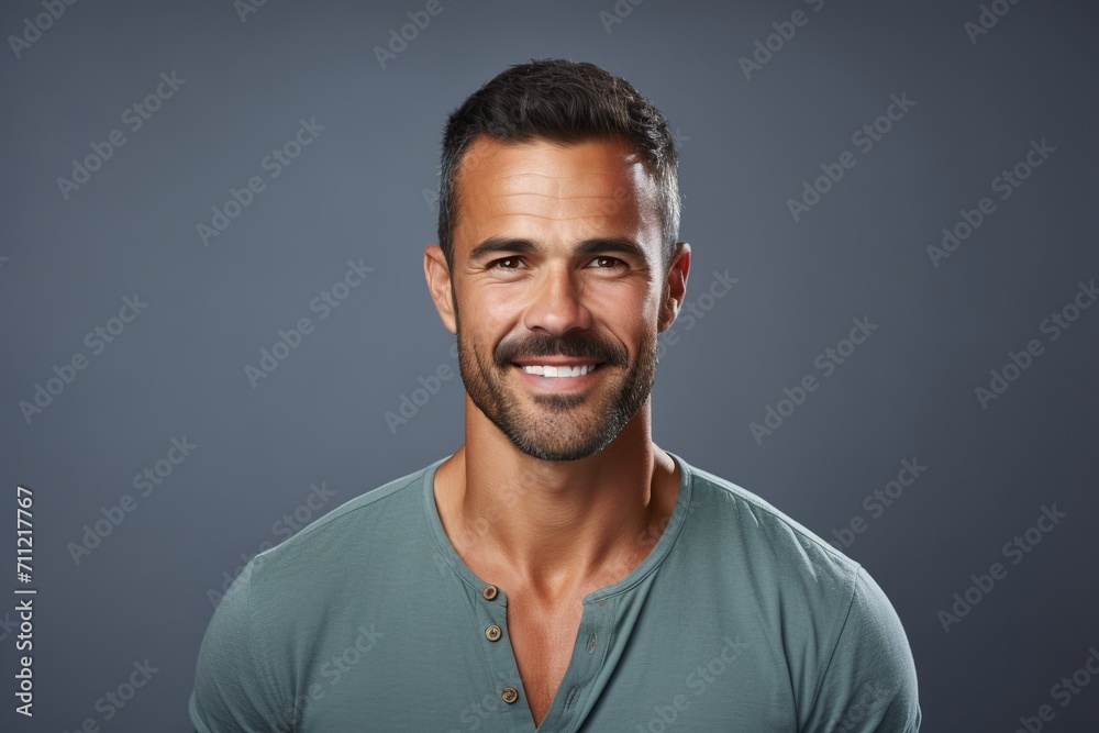 Portrait of handsome young man in casual t-shirt on grey background Portrait of handsome young man in casual t-shirt on grey background