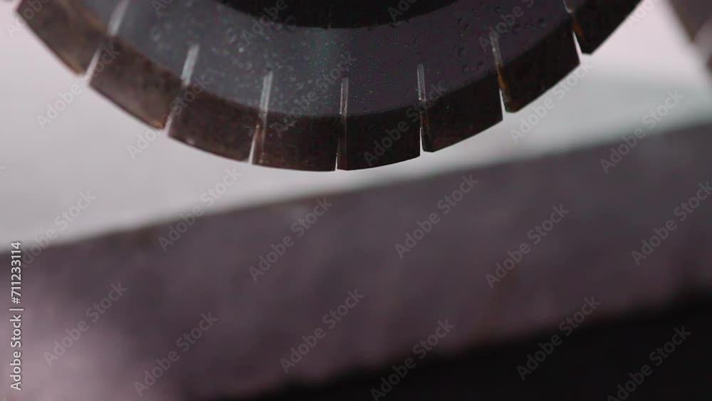 Close Up. Positioning Sharp Saw Blade Of Processing Machine Above Stone Material. Processing Machines Saw Blade Preparing To Cut Granite Rock. Segmented Saw Blade Of Industrial Processing Machine Close Up. Positioning Sharp Saw Blade Of Processing Machine Above Stone Material. Processing Machines Saw Blade Preparing To Cut Granite Rock. Segmented Saw Blade Of Industrial Processing Machine