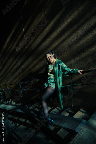 Portrait of a young Asian woman posing in the subway near the stairs. 