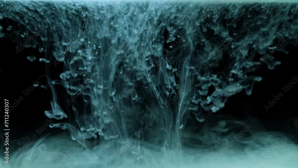 Abstract Ink Water White paint drops from above mixing in water. Ink swirling underwater ...