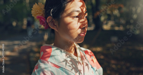 Face, thinking or Asian woman in nature for journey on holiday, vacation for freedom or wellness. Girl, travel or Japanese female person with ideas for calm, peace or inspiration to relax in park