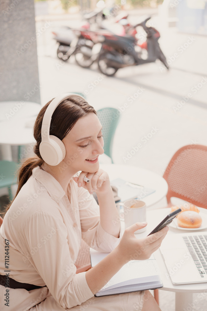 Caucasian Female enjoy the music through the wireless headphone on her phone
Caucasian Female enjoy the music through the wireless headphone on her phone