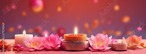Burning candles with colorful decorations on a pink background.