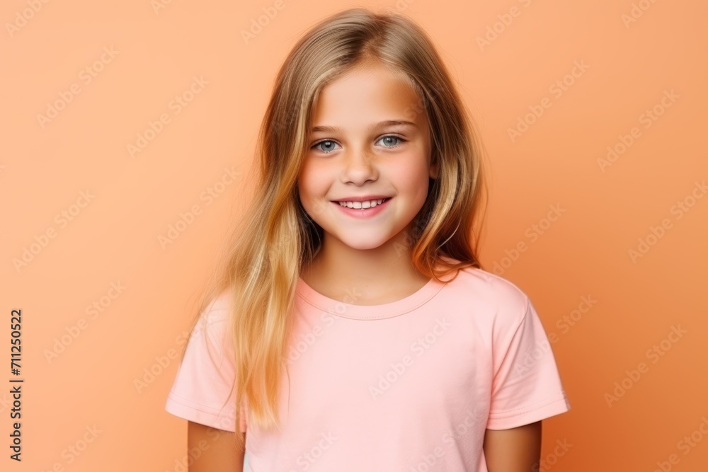 Portrait of a cute little girl on a orange background. Beauty, fashion.