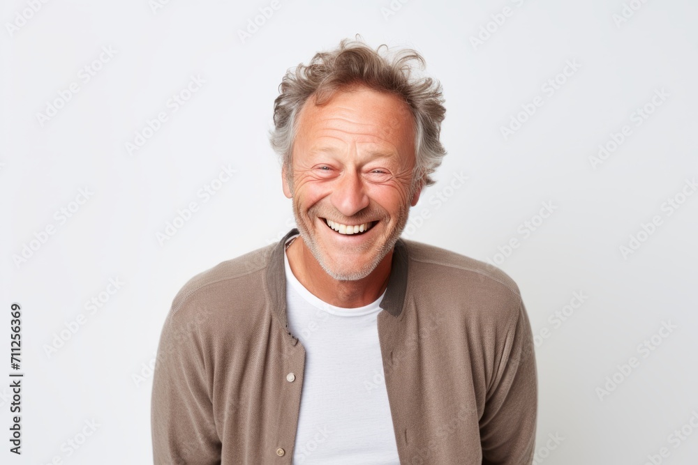 Portrait of a happy senior man laughing at camera against white background Portrait of a happy senior man laughing at camera against white background