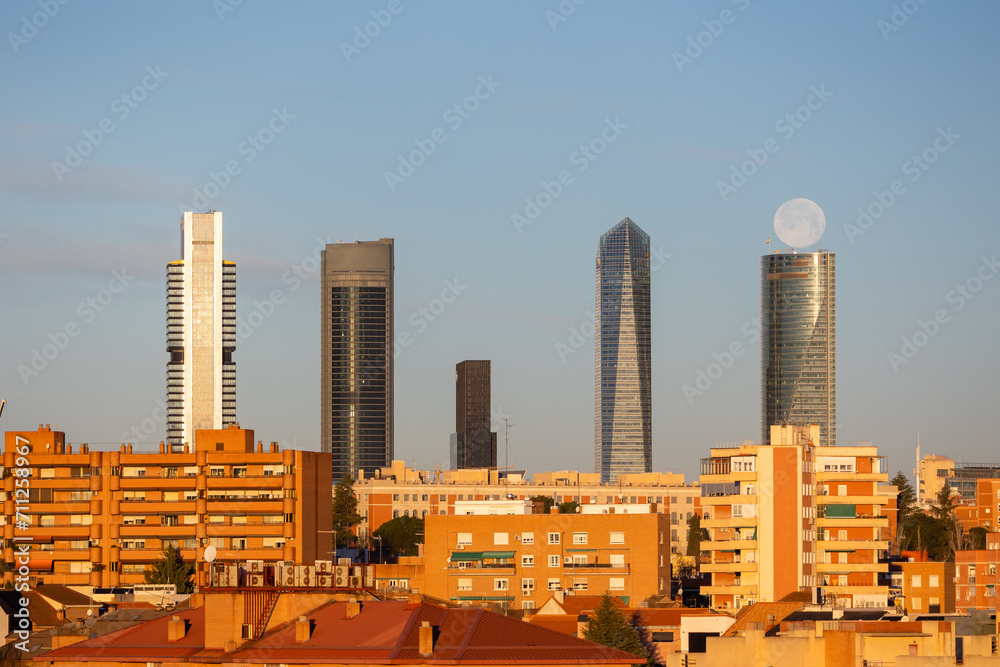 Fototapeta premium The moon over the four towers in the city of Madrid, Spain
