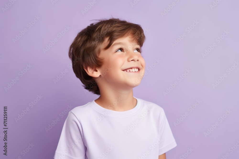 Portrait of a cute little boy in a white T-shirt on a purple background Portrait of a cute little boy in a white T-shirt on a purple background