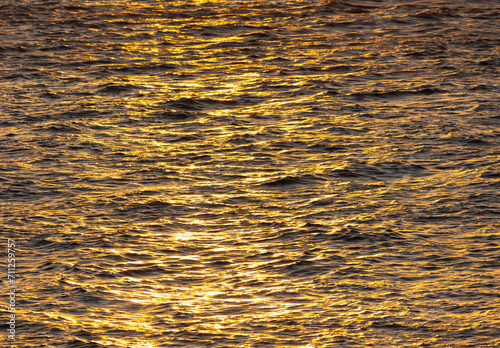 Golden water of the sea at sunset. Background