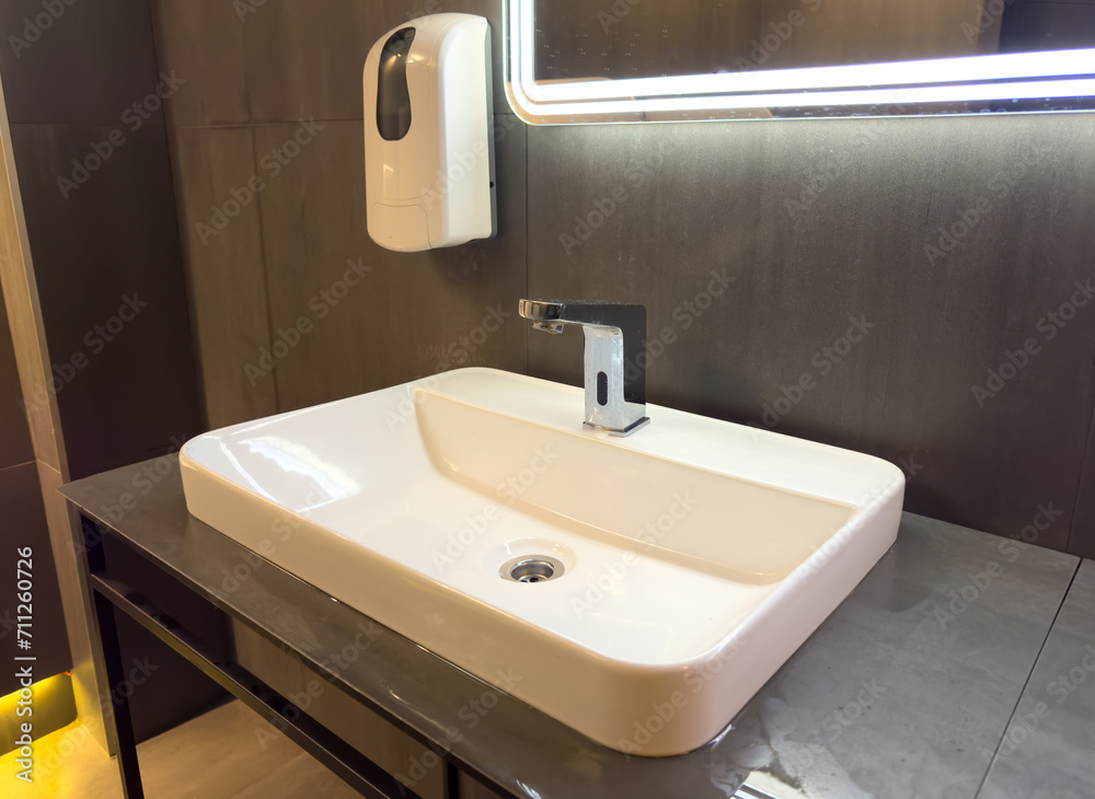 White washbasin with tap in the restroom White washbasin with tap in the restroom