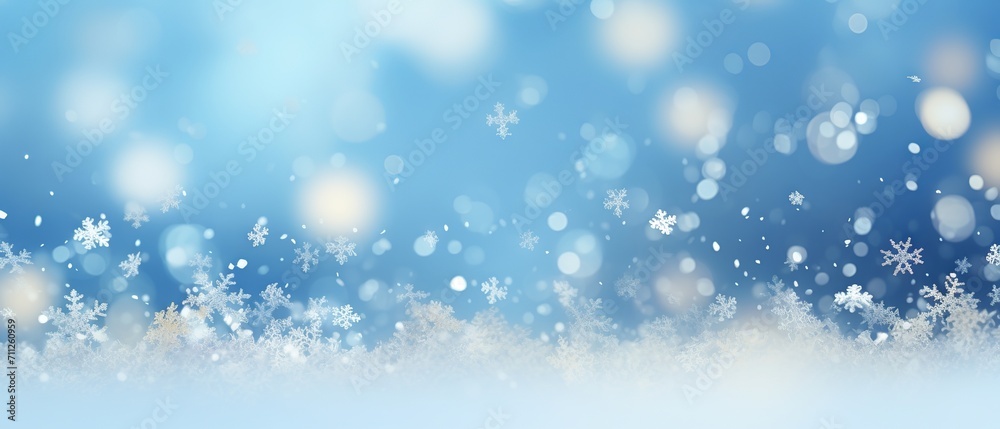 Snowy winter scene with sparkling bokeh effect on blue background