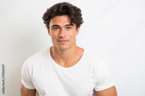 Portrait of handsome young man in white t-shirt on white background