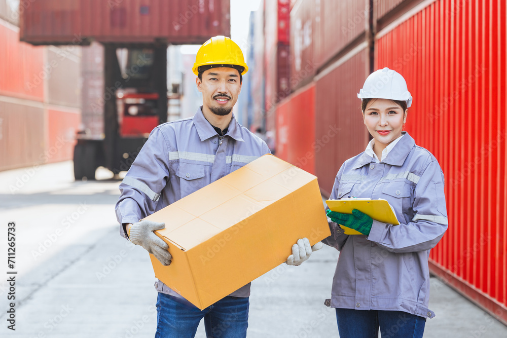 Asian man and women team workers customs staff teamwork in container yard port shipping cargo logistics industry. Asian man and women team workers customs staff teamwork in container yard port shipping cargo logistics industry.