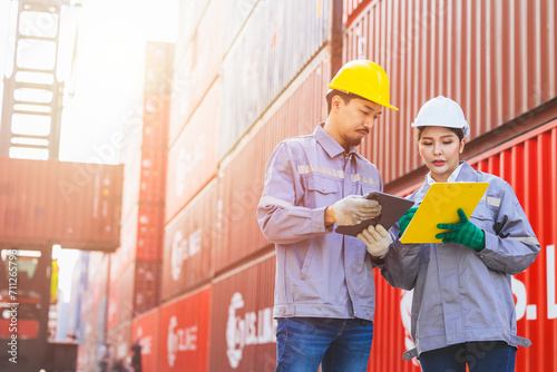 Canvas Print Asian man and women team workers customs staff teamwork in container yard port shipping cargo logistics industry