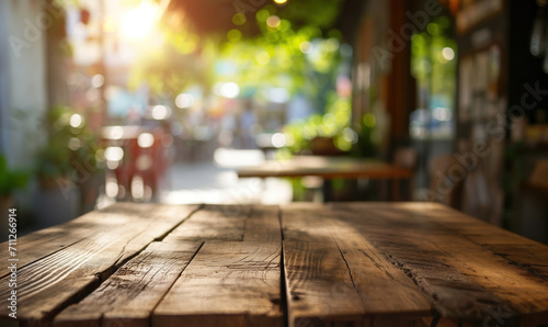 Empty wooden table with sunny cozy cafe interior on background