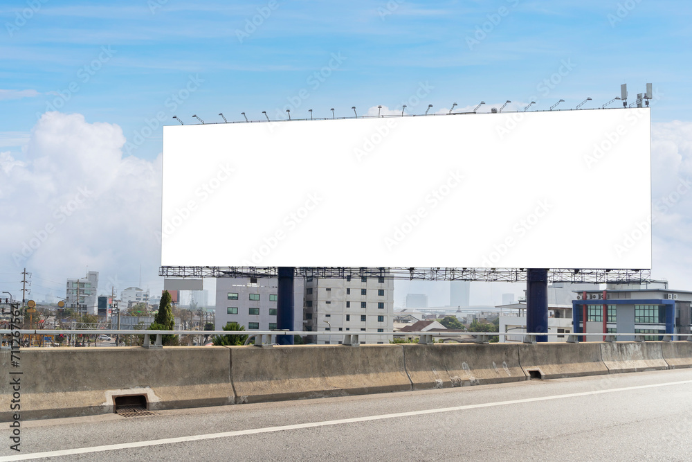 Empty billboard on the side of a highway. The billboard is located in a city, and it is facing the highway. The billboard is large and rectangular. Empty billboard on the side of a highway. The billboard is located in a city, and it is facing the highway. The billboard is large and rectangular.