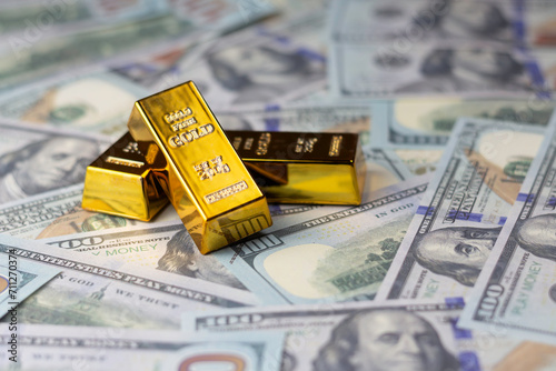 Gold bars arranged on dollar bills Guidelines for wealth, finance, investment and savings.