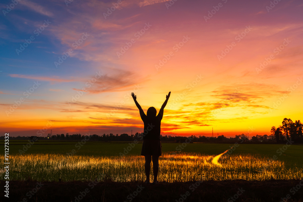 Scenic view landscape of woman relaxing in summer in mud and water reflection with Twilight blue bright and orange yellow dramatic sunset sky in beach cloudscape air background.People freedom style. Scenic view landscape of woman relaxing in summer in mud and water reflection with Twilight blue bright and orange yellow dramatic sunset sky in beach cloudscape air background.People freedom style.