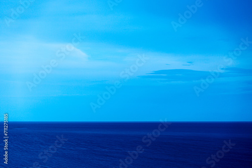Landscape in blue with sea and cloudy dramatic sky © rninov
