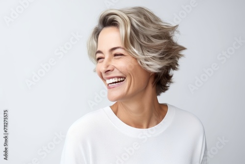 Portrait of a beautiful middle-aged woman with short hair smiling © Inigo