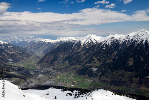 Chain of snow-capped Alpine mountains. Valley. View from top. photo