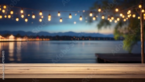 Empty Wood table top with decorative outdoor  lights hanging at night time,	

