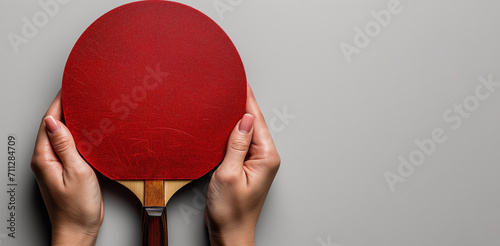 Red table Tenis racket in hands on white background. Ping pong horizontal banner. World Table Tennis Day