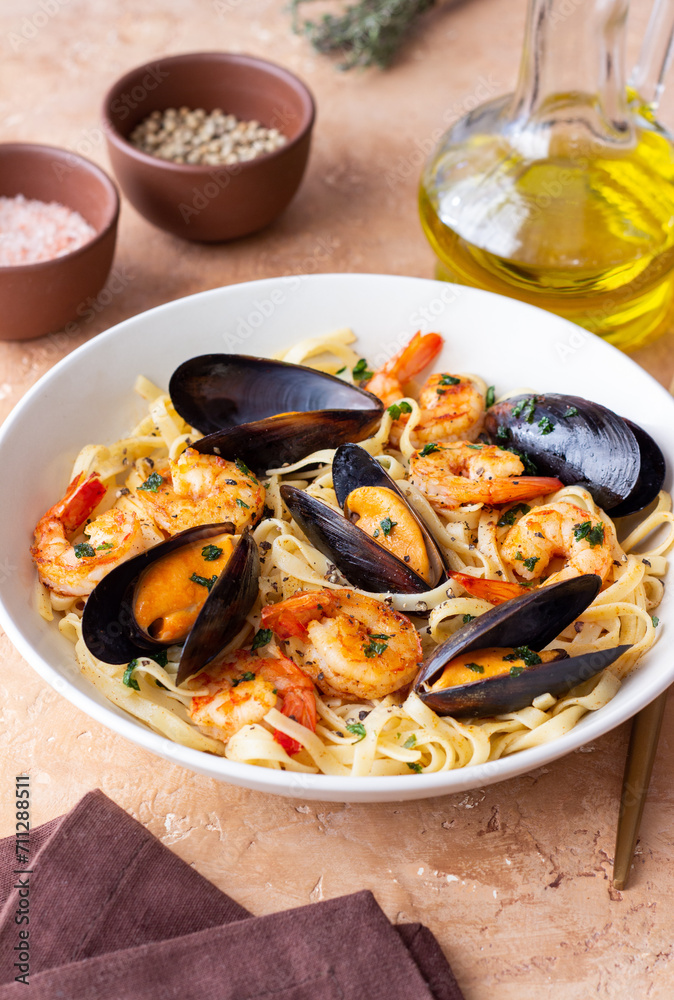 Tagliatelle pasta with shrimps and mussels. Seafood. Italian cuisine.